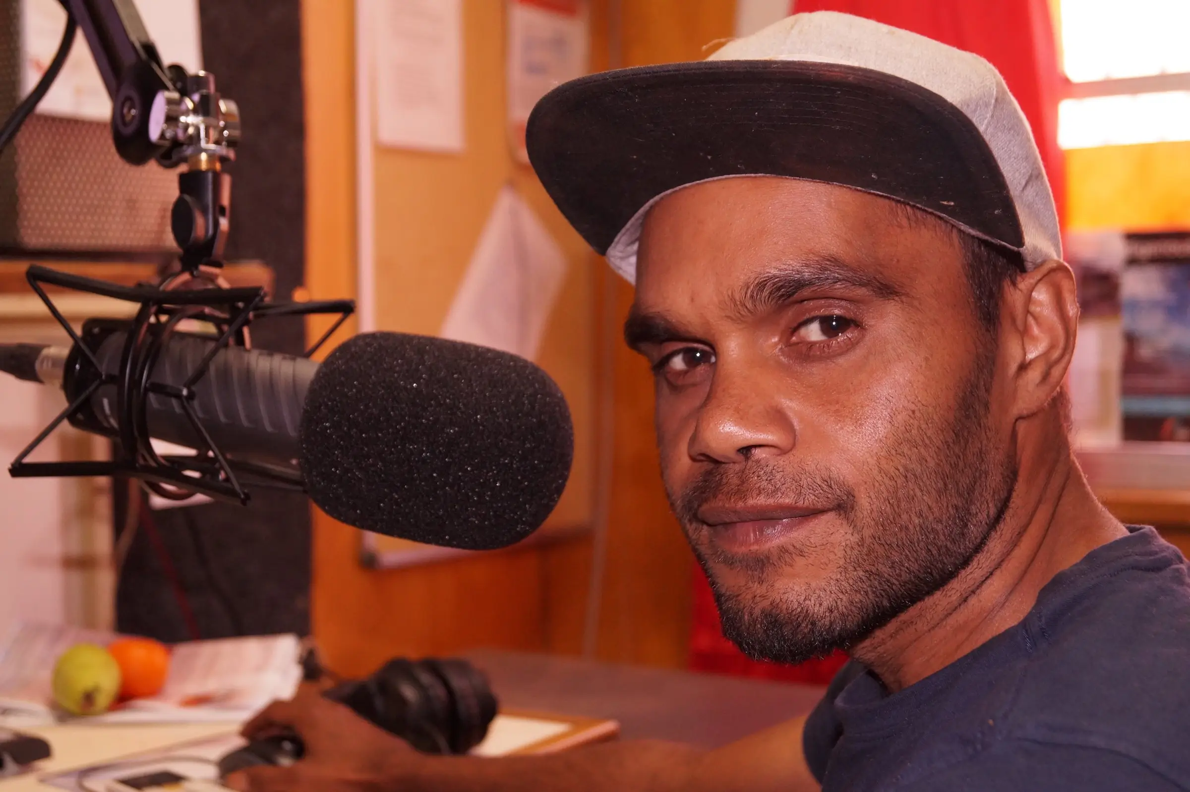 Broadcaster at the microphone during an outside broadcast, Mimili