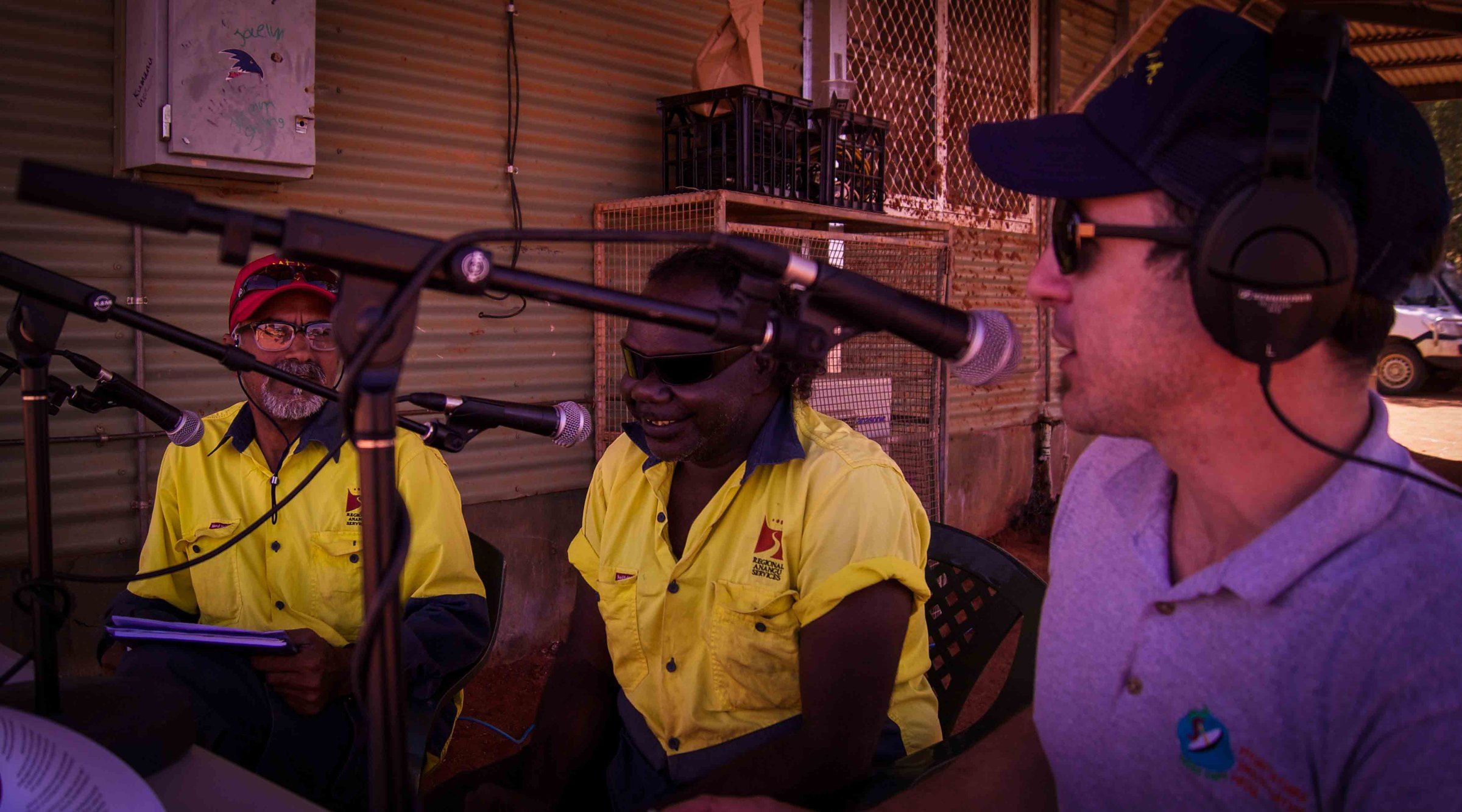 Three broadcasters at the microphones during an outside broadcast