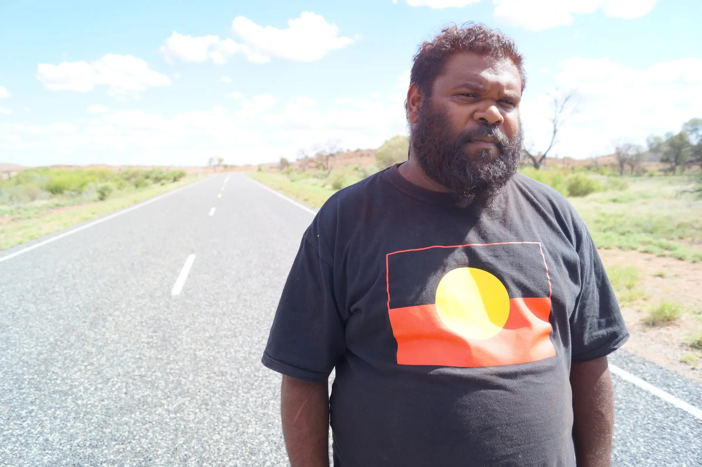 Person standing on the road outside a community