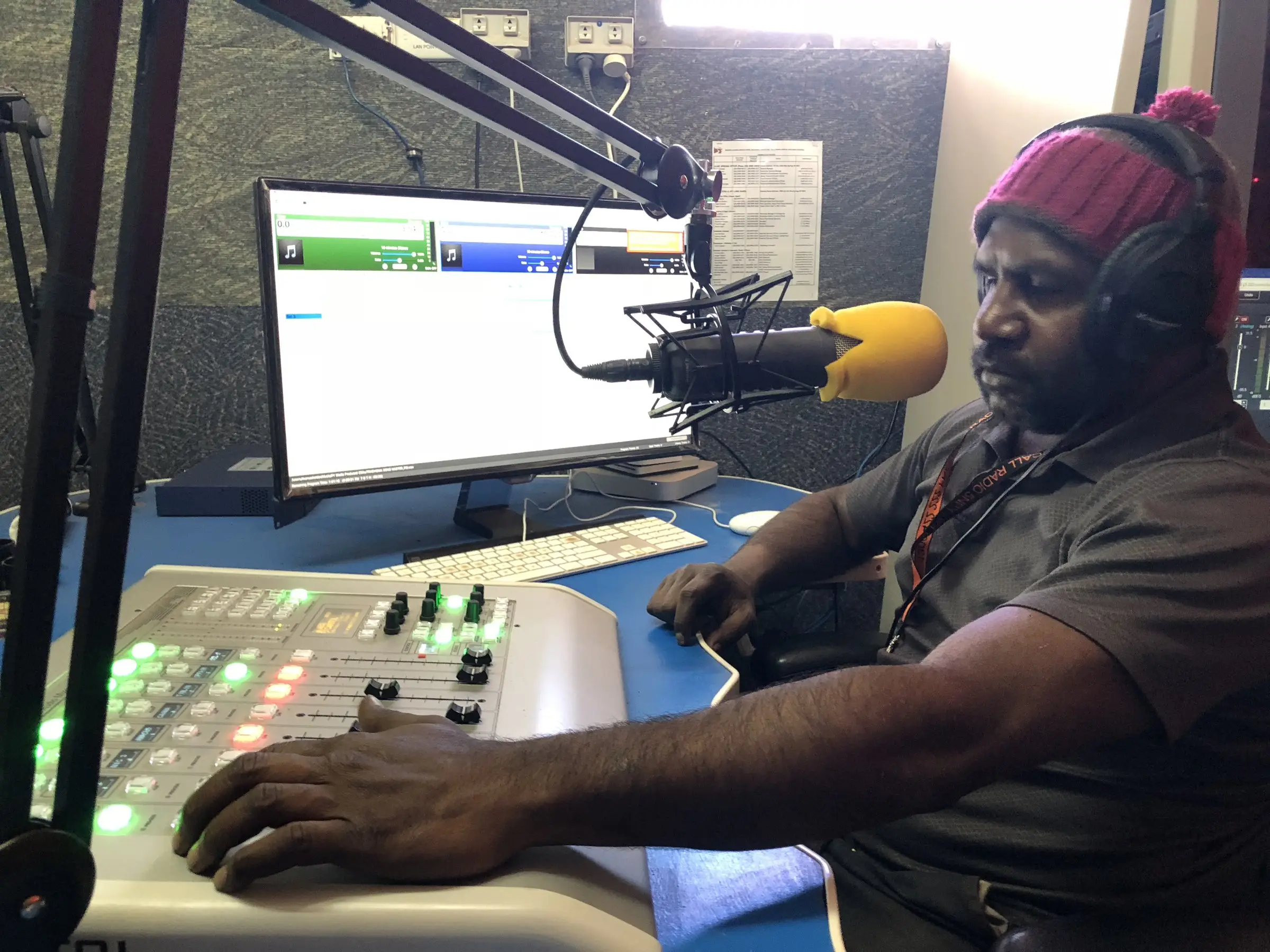 Broadcaster at the Radio 5NPY studio desk, Umuwa